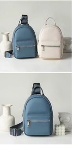 Detail of lychee textured leather bags in blue and white with silver metal hardware