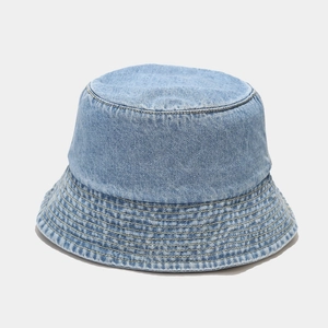 Detailed close-up showing the stitching and texture of the light blue denim bucket hat