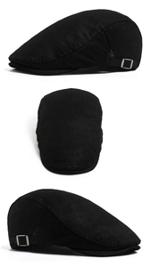 Detail view of adjustable silver metal buckle and washed black fabric on the flat cap