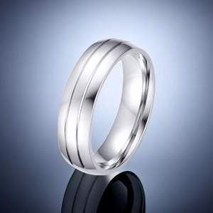 Macro shot of polished silver titanium steel ring featuring parallel decorative grooves