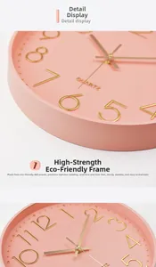 Detailed view of pink ABS plastic wall clock frame and golden 3D numeric dial texture