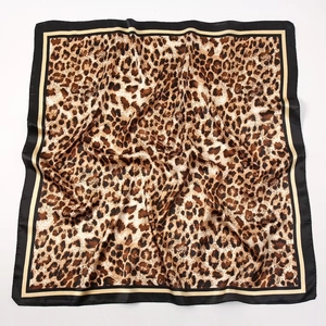Detailed view of large leopard print satin square scarf with gold and black borders