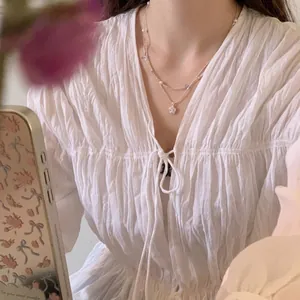 Double layer necklace with star pendant and pearl beads on a fashion model