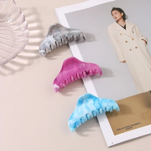 Detailed set of three large marble pattern hair claws in grey, pink, and blue acetate
