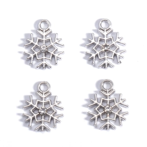 Close-up of silver snowflake pendants with central zircon for DIY jewelry making