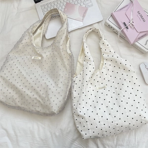 Detail view of stylish organza tote bag with polka dots and heart pattern design