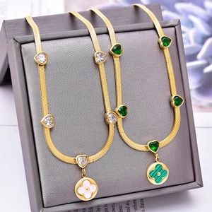Golden snake chain necklace with heart zircon and clover shell pendant in elegant display
