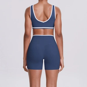 Women's blue contrast trim yoga set featuring cross back bra and high waist biker shorts