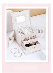 Detail view of pink leather jewelry box with multi-layer storage, mirror, and drawers