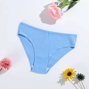 Blue ribbed cotton panties for women with breathable fabric on a floral background