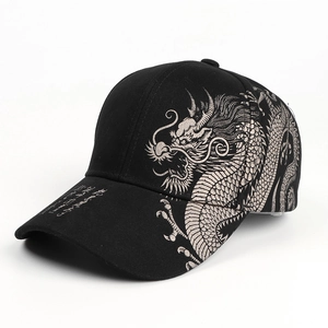 Detail view of the silver dragon embroidery and Chinese calligraphy on a black baseball cap