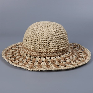 Macro view of checkered hand-woven straw hat showing natural raffia texture and pattern