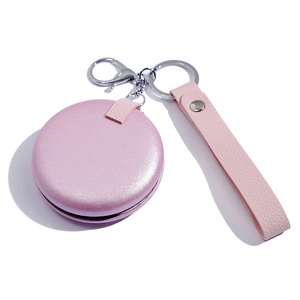 Pink round leather folding pocket mirror with wrist strap and metal keychain loop