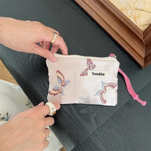 Detailed macro of vintage butterfly jacquard fabric and pink rope zipper puller