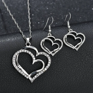 Hollow heart jewelry set with necklace and earrings featuring white crystal stones