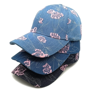 Three denim baseball caps in blue and black with embroidered pink floral patches