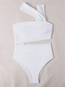 Flat lay detail of white one-shoulder swimsuit with waist cutouts on textured background