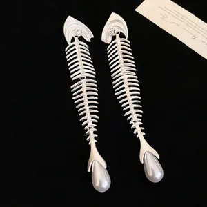 Silver fishbone earrings with sparkling crystals and elegant white teardrop pearls