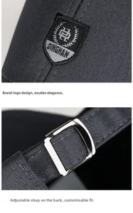 Detail of adjustable metal strap and shield embroidery on black cotton baseball cap