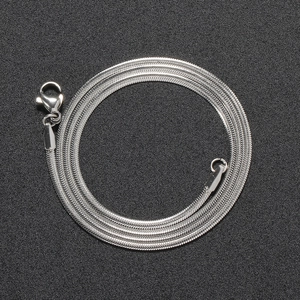 Detailed macro view of silver 2mm stainless steel snake chain with lobster clasp
