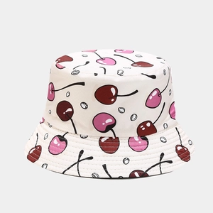 Detail of cotton bucket hat featuring red cherry patterns and reinforced stitched brim
