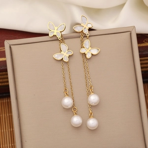Elegant gold butterfly earrings with white mother of pearl and pearls on white silk