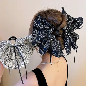 Elegant acrylic hair claw clip with paisley fabric bow, pearls and long tassels