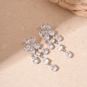 Macro view of silver floral zircon tassel earrings with pear-cut stones and drop design