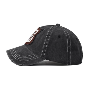 Close-up of distressed washed cotton baseball cap with embroidered shield patch