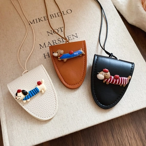 Detail showing high-quality leather card sleeves with cute cartoon dachshund decorations