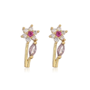 Macro detail of gold flower stud earrings with pink and white zircon stone petals