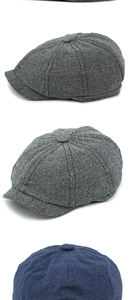 Detail of vintage herringbone newsboy caps showing black, white and navy fabric textures