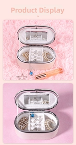 Detail of portable beige jewelry box interior with mirror and multi-compartment storage