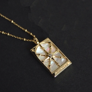 Vintage gold star and moon necklace featuring a rectangular white shell pendant
