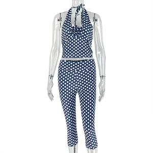 Detail of navy blue polka dot halter top and cropped leggings set for summer fashion