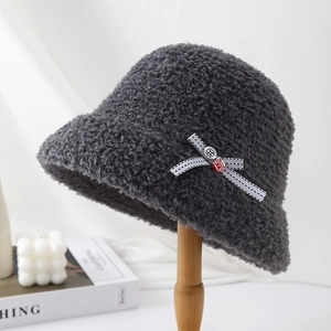 Close-up detail showing the soft fuzzy texture and bow accent of a grey winter bucket hat