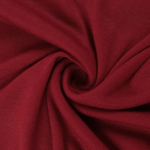 Detailed macro view of the dark red rose pleated knit fabric texture and elegant draping