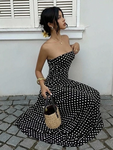 Detail of elegant black and white polka dot off-the-shoulder A-line dress with woven texture