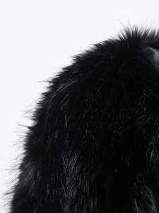 Detailed close-up of soft black faux fur texture on this stylish cropped jacket