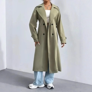 Detail of elegant sage green double-breasted trench coat with lapel collar and long sleeves