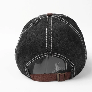 Back view of vintage denim baseball cap featuring brown suede strap and metal buckle