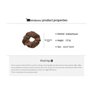 Close-up of brown knitted scrunchie showing 12cm size, fabric texture and fashion tag