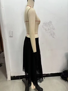 Detail view of the black lace skirt featuring a stylish asymmetrical hemline design
