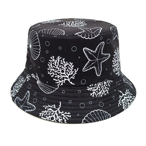 Detail of black cotton bucket hat showing white starfish and seashell patterns