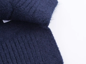 Detailed macro view of dark blue ribbed knit fabric texture with soft wool-like fuzzy finish