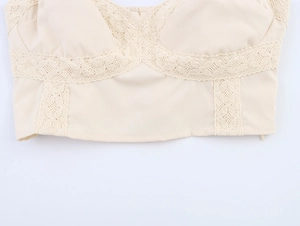 Close-up of beige camisole featuring intricate lace patchwork and cotton linen texture