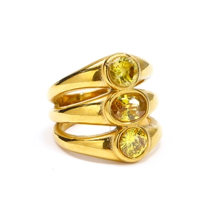 Detailed view of three-piece gold-plated titanium rings with yellow oval zircon stones