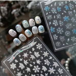 Close-up of winter snowflake nail art stickers with glitter finish and rhinestones