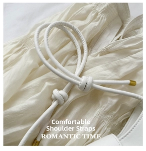 Detail of white pleated shoulder bag with knotted strap and gold metal aglets