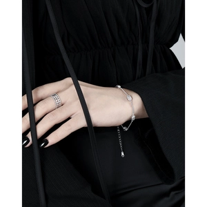 Silver openwork mesh ring and oval diamond bracelet set worn by a model